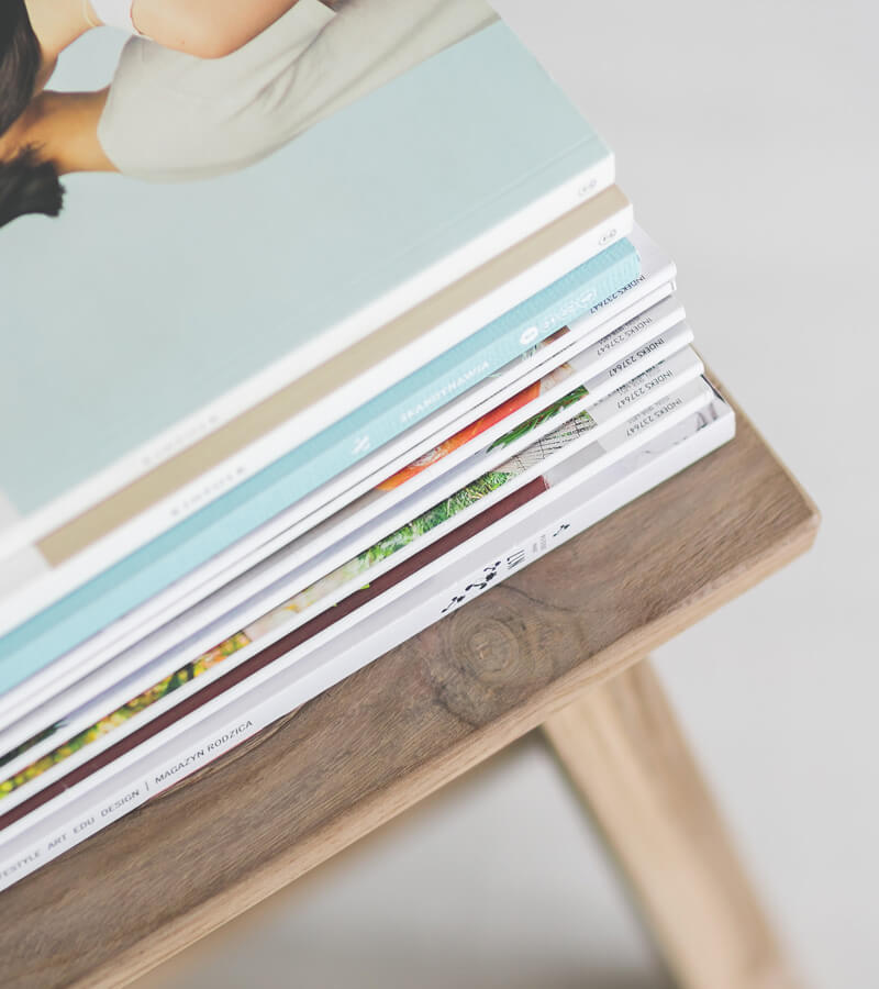 An image of magazines on a chair that represent the print design solutions available at not fade away. 