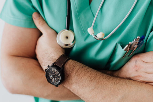 An image of a physician with arms crossed thinking about Healthcare web design solutions. 