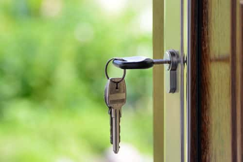 An image of keys in a door of a new house. 